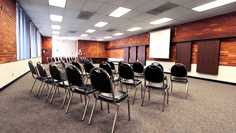 Chairs setup in a theater style facing projector screen.